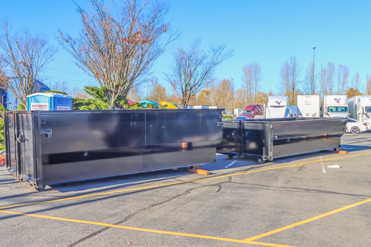 Professional dumpster rental service with roll-off container on residential driveway in Oildale